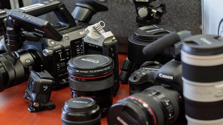 Cameras and lenses arranged on a table